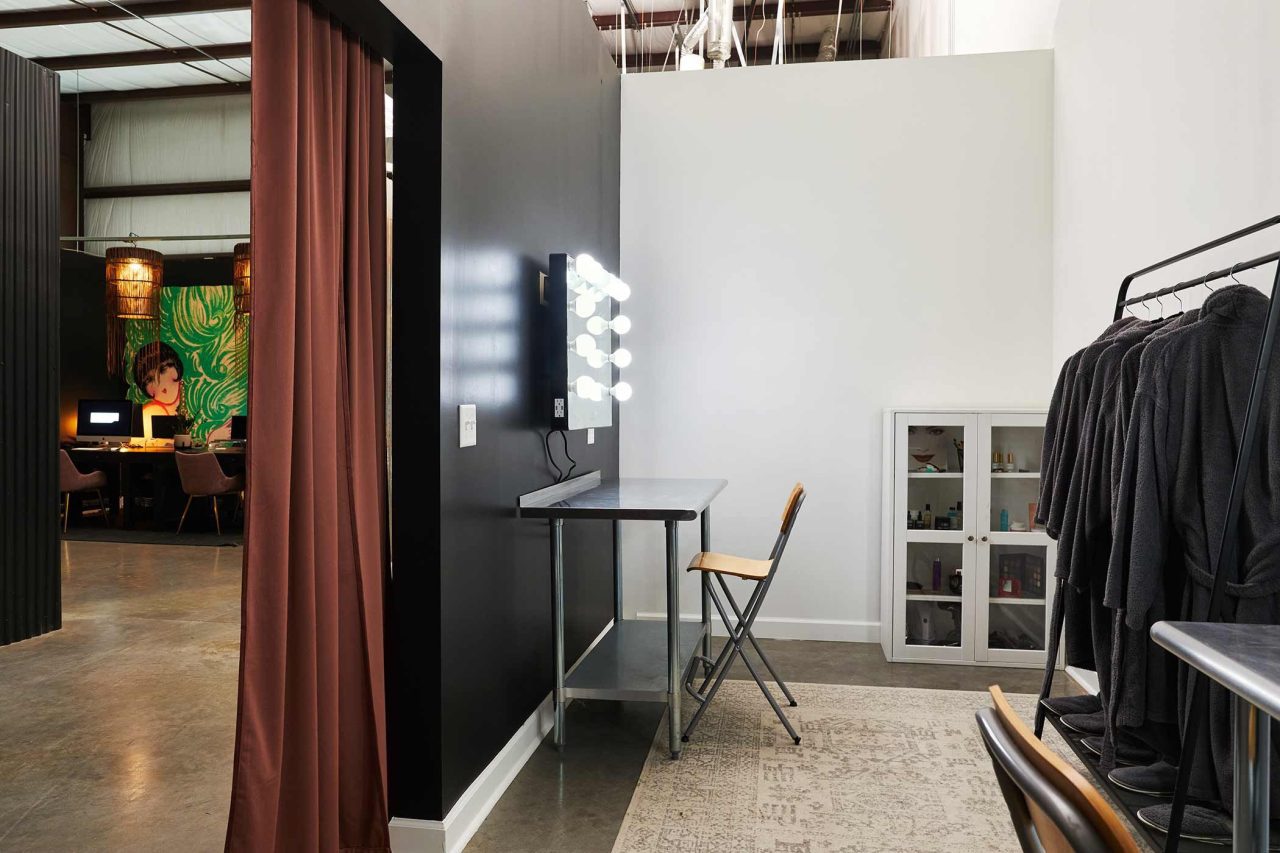 Interior photograph of a wardrobe and dressing room backstage on a creative studio set.