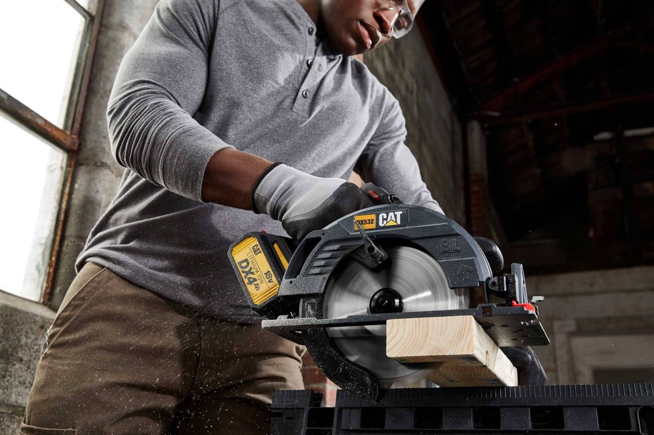 Low-angle photograph of a person using a circular saw.