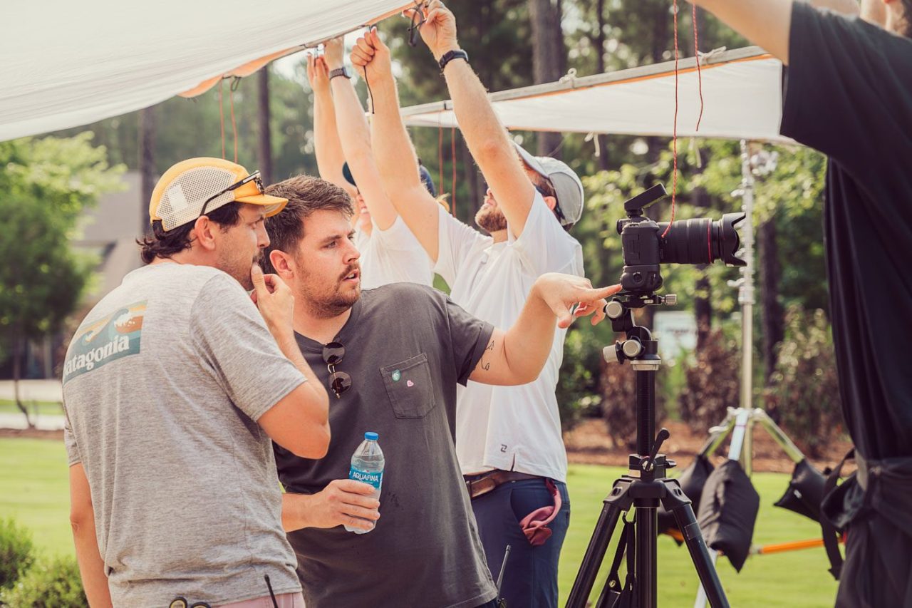 Team giving creative direction on the outdoor set of a lifestyle photoshoot.