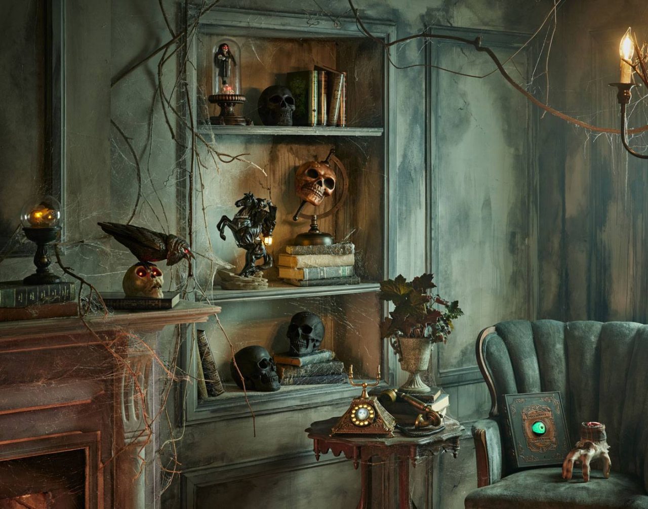 A dimly lit, spooky room with a shelf displaying skulls, old books, a raven statue, and antique objects. Cobwebs hang from a chandelier. A vintage armchair and side table with an intricate clock complete the eerie atmosphere.