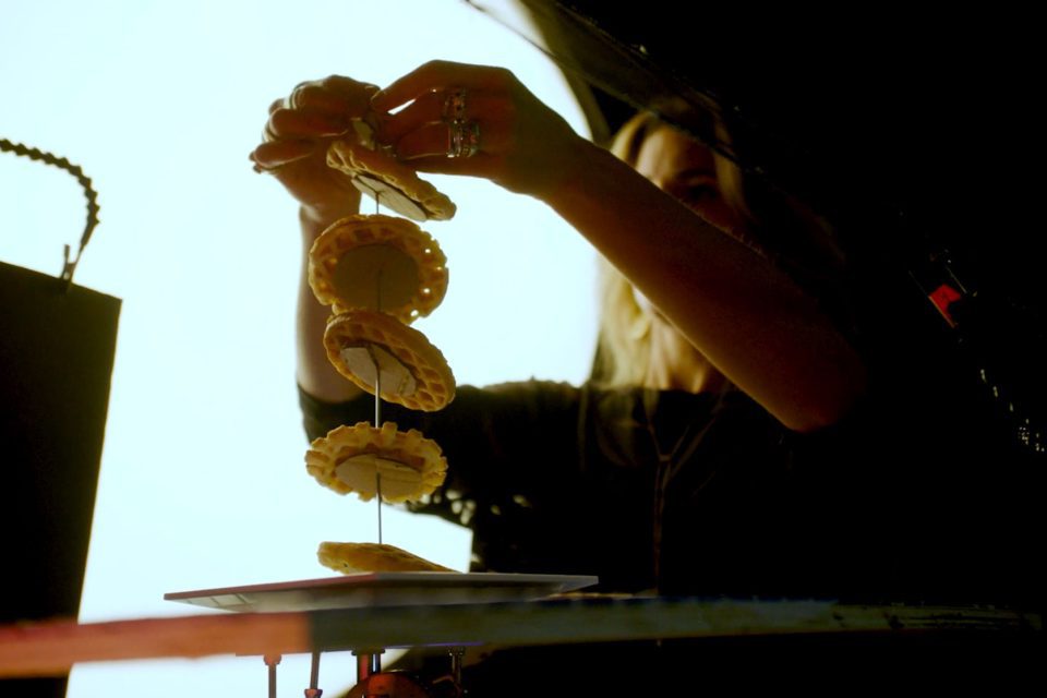 Food stylist arranging a composition for a photoshoot.