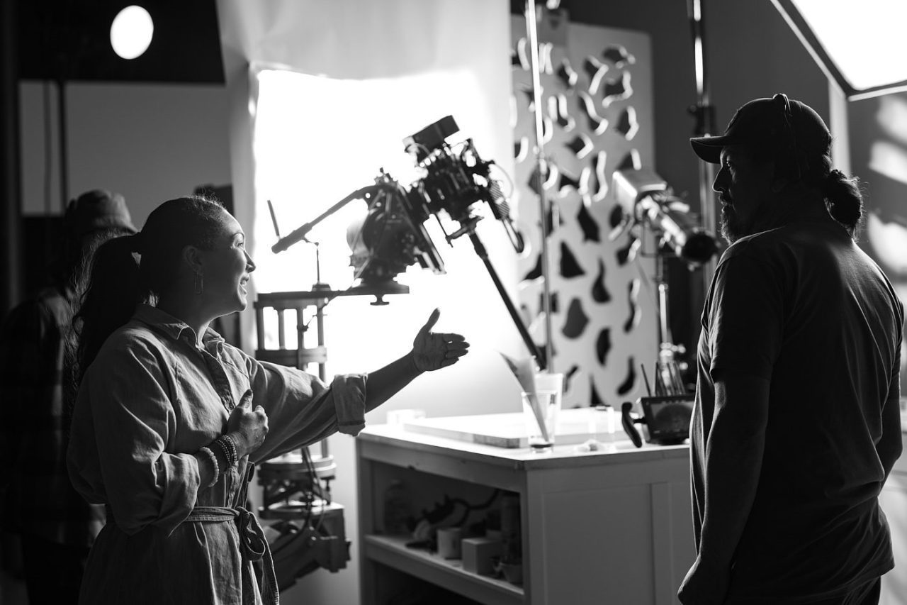 Black and white photograph of creative team behind the scenes at a photoshoot.