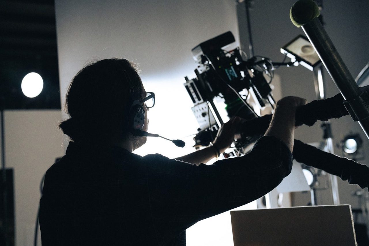 Food photographer working behind the scenes on a state-of-the-art camera.