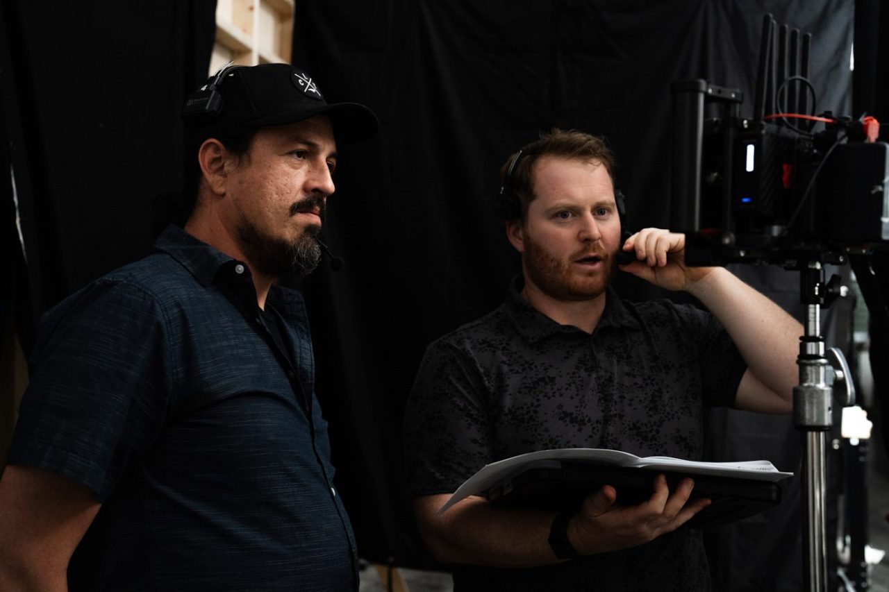 Crew members on headsets on the set of a creative studio production.