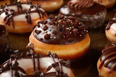 Dramatic close-up photograph of chocolate glazed donuts.