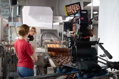 Studio team working with cameras managing the set of a food photography shoot.