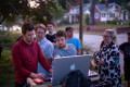 Expert on location photography crew gathered around laptop.