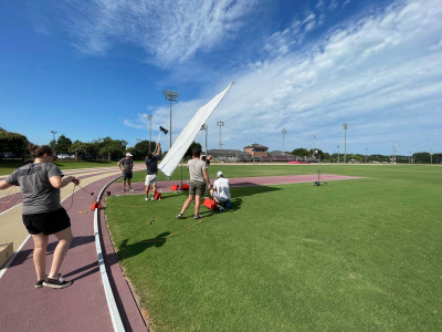 Outdoor athletic field photography crew.