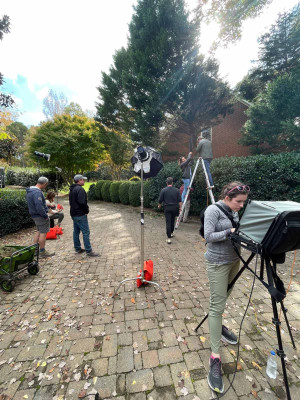 Camera crew setting up outside for a photoshoot.