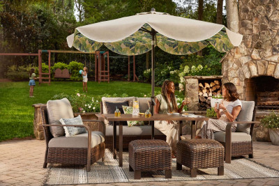 Backyard summer scene with two women talking in patio chairs.