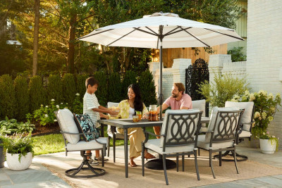 Photograph of a backyard patio with a family drinking lemonade.