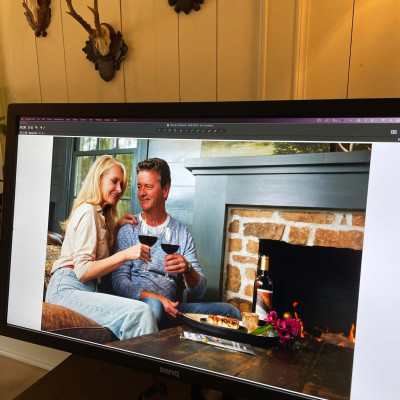 Image of a laptop screen displaying photograph of a couple drinking wine.